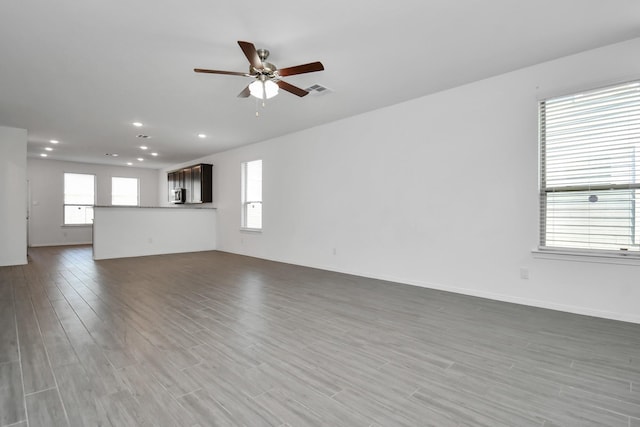25489 Northpark Spruce Dr, Porter, TX 77365 - unfurnished living room with light wood-style floors, a ceiling fan, baseboards, recessed lighting, and visible vents