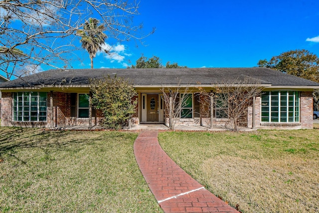ranch-style house with a porch, a front lawn, and brick siding