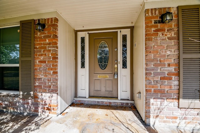 entrance to property with brick siding