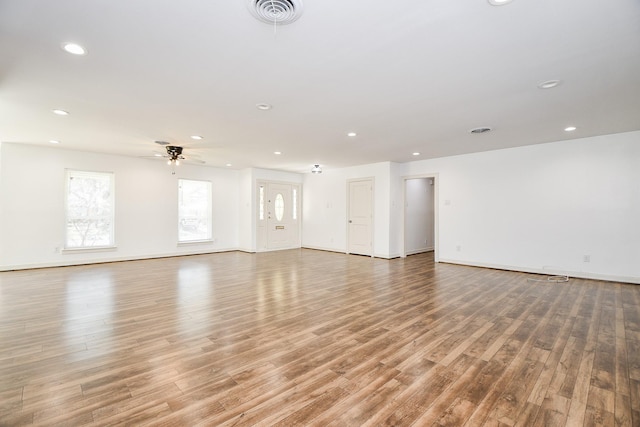 unfurnished living room featuring ceiling fan, light wood-style flooring, recessed lighting, baseboards, and visible vents