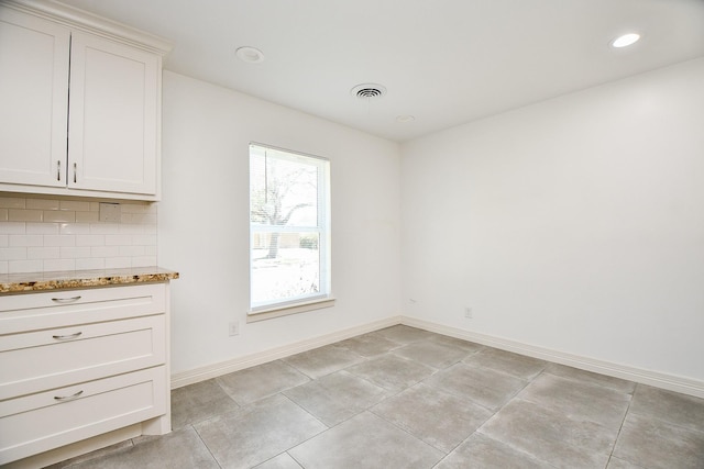 unfurnished dining area with recessed lighting, baseboards, and visible vents