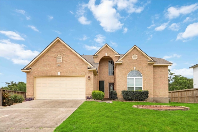 traditional home with brick siding, fence, driveway, and a front yard