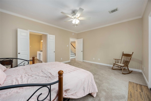 bedroom with crown molding, baseboards, visible vents, and light carpet