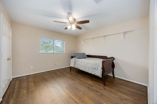 bedroom featuring baseboards, visible vents, ceiling fan, and hardwood / wood-style floors