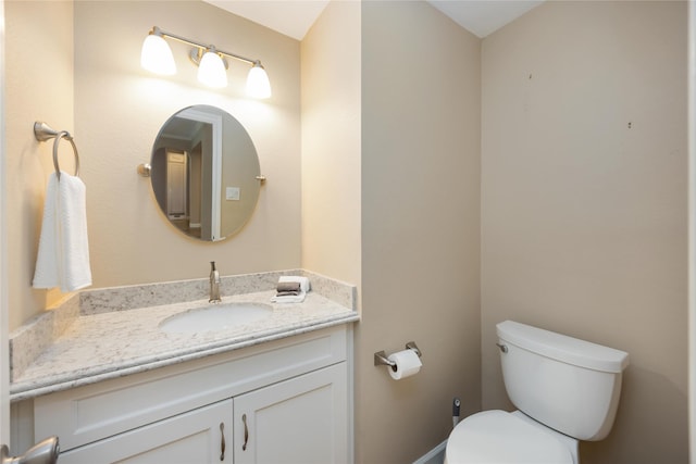 half bath featuring toilet and vanity