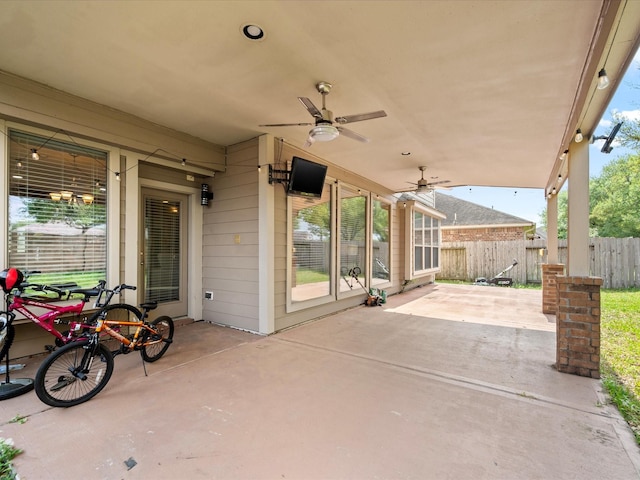 view of patio featuring ceiling fan and fence