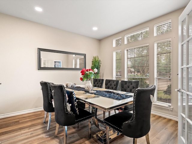 dining area with recessed lighting, baseboards, and wood finished floors