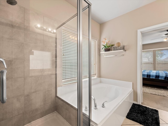 ensuite bathroom featuring ceiling fan, a bath, a shower stall, tile patterned floors, and ensuite bath
