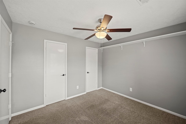 unfurnished bedroom featuring a ceiling fan, baseboards, and carpet