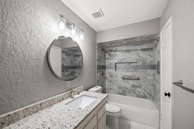 full bathroom featuring visible vents, vanity, a textured wall, toilet, and shower / washtub combination