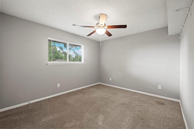 carpeted empty room with baseboards, a ceiling fan, and a textured ceiling