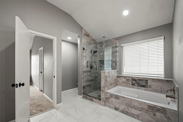 bathroom with marble finish floor, baseboards, a shower stall, vaulted ceiling, and a garden tub