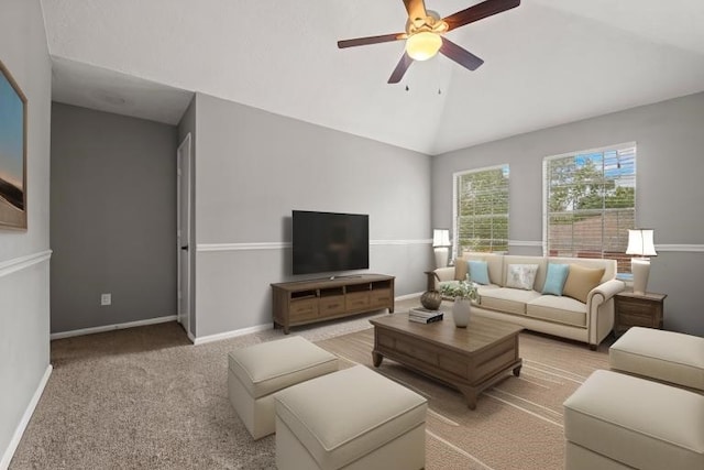 living area featuring vaulted ceiling, baseboards, a ceiling fan, and light colored carpet