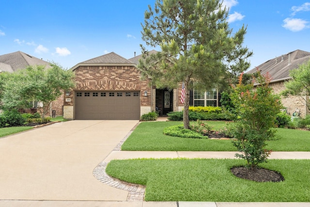 view of front of property featuring a front yard, roof with shingles, brick siding, concrete driveway, and an attached garage