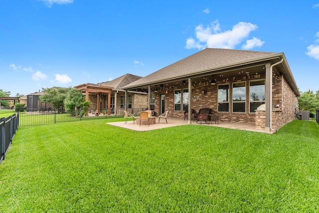 rear view of property with a fenced backyard, central AC unit, ceiling fan, and a lawn