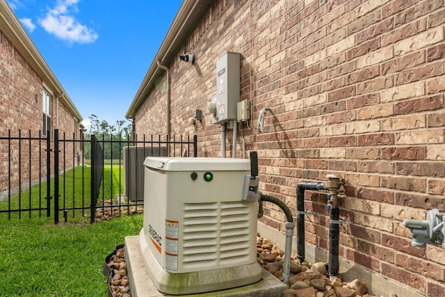 exterior details with fence, central air condition unit, a power unit, and brick siding