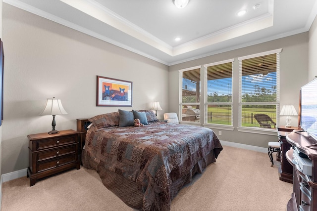 bedroom featuring crown molding, a raised ceiling, baseboards, and light carpet