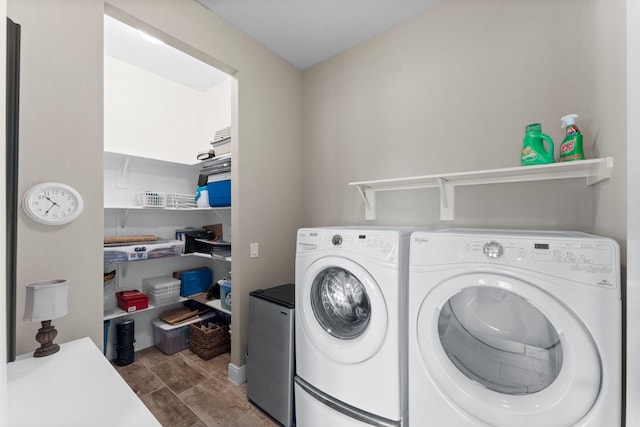 laundry area featuring washing machine and clothes dryer and laundry area