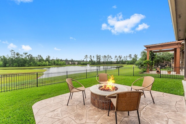 view of patio / terrace featuring a water view, a fire pit, and fence