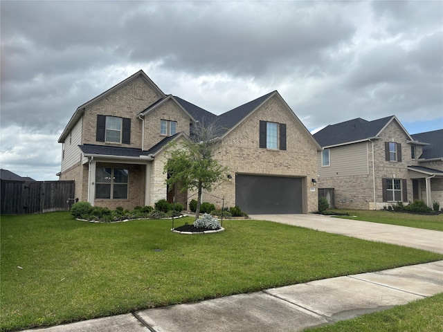 traditional-style home featuring a garage, a front lawn, fence, brick siding, and concrete driveway
