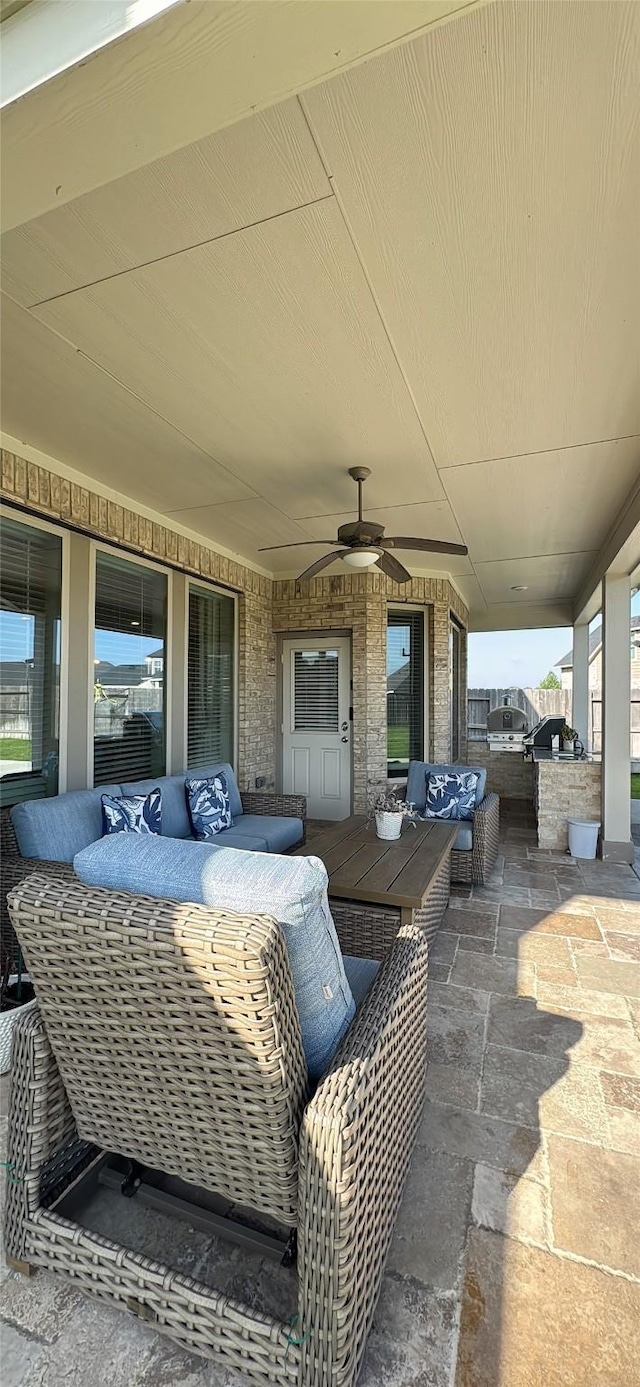 view of patio / terrace featuring an outdoor living space, ceiling fan, and outdoor dining space