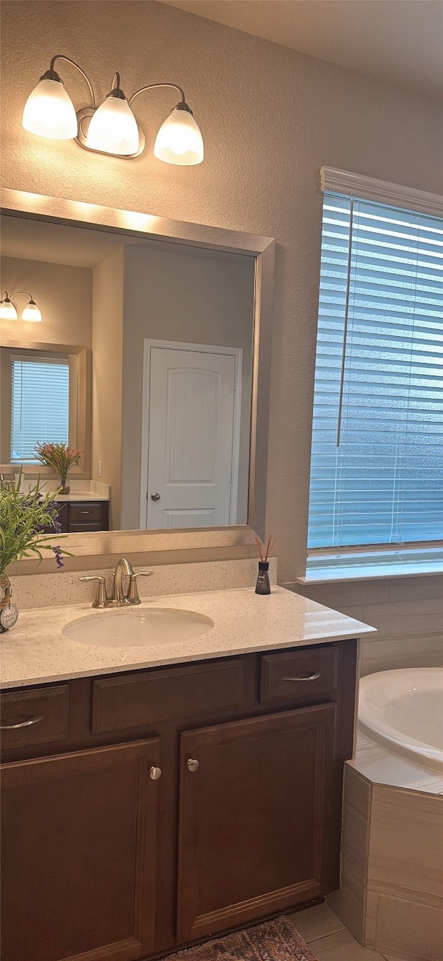 1819 Bending Willow Ln, Katy, TX 77494 - bathroom featuring vanity, a bath, and a textured wall
