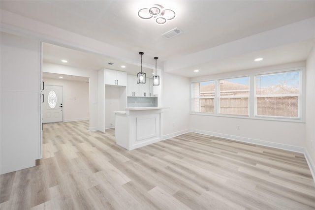 7425 Rhobell St, Houston, TX 77016 - unfurnished living room featuring light wood-style floors, baseboards, recessed lighting, and visible vents