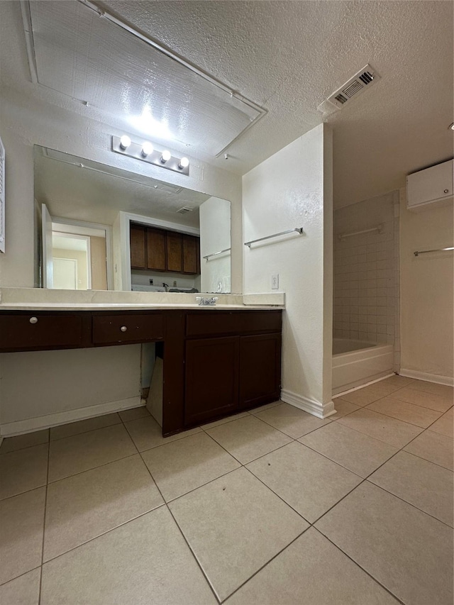 bathroom featuring visible vents, vanity, a shower, baseboards, and tile patterned floors