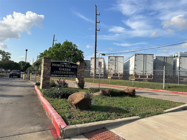 community sign featuring fence