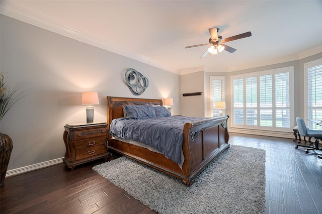 bedroom featuring ornamental molding, dark wood finished floors, baseboards, and a ceiling fan
