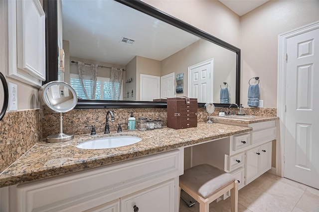 bathroom with backsplash, double vanity, and tile patterned floors