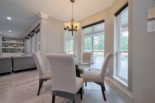 dining room featuring a chandelier, light wood finished floors, baseboards, and recessed lighting