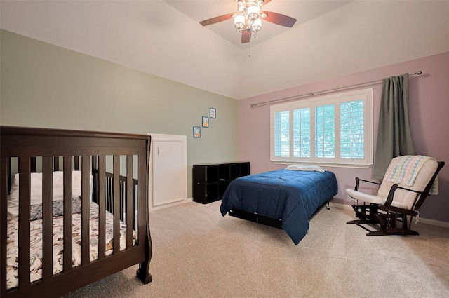 carpeted bedroom with baseboards, vaulted ceiling, and a ceiling fan
