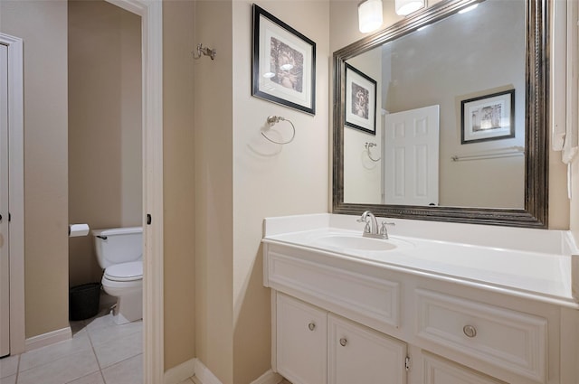 bathroom featuring tile patterned floors, toilet, vanity, and baseboards