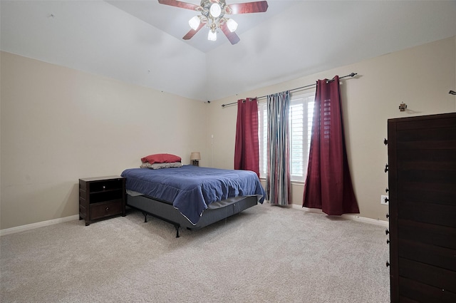 bedroom with light carpet, vaulted ceiling, baseboards, and ceiling fan