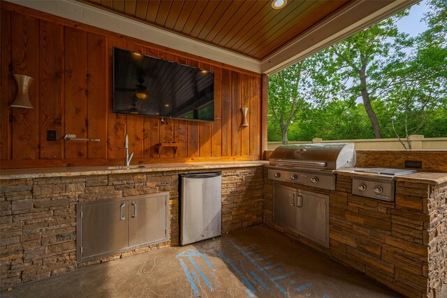 view of patio with a grill, an outdoor kitchen, and a sink