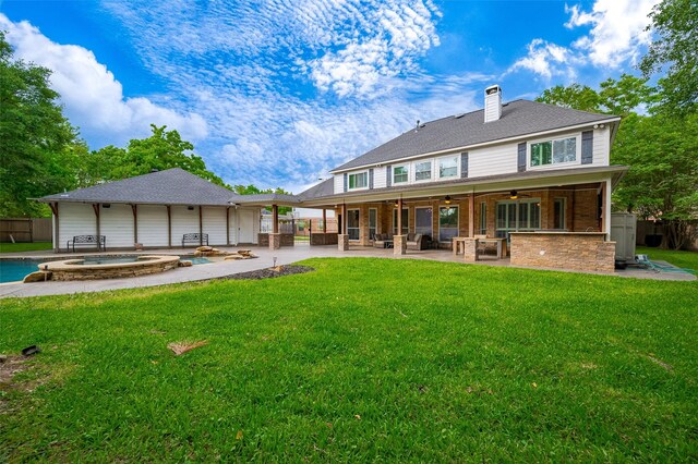 back of house with an in-ground hot tub, ceiling fan, a patio area, and a chimney