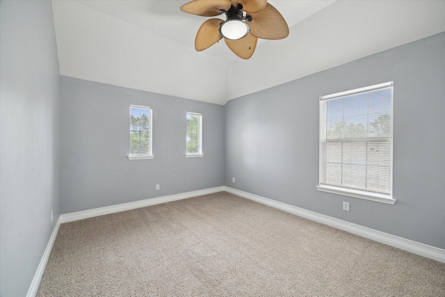 carpeted spare room featuring baseboards, ceiling fan, and lofted ceiling