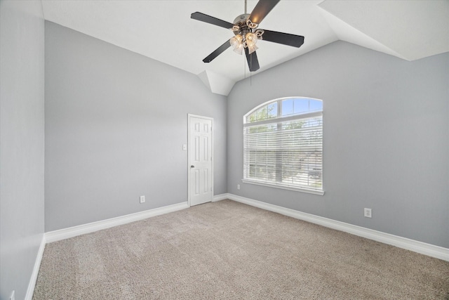 unfurnished room featuring baseboards, a ceiling fan, vaulted ceiling, and carpet flooring