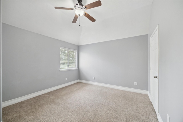 spare room with carpet flooring, ceiling fan, baseboards, and lofted ceiling