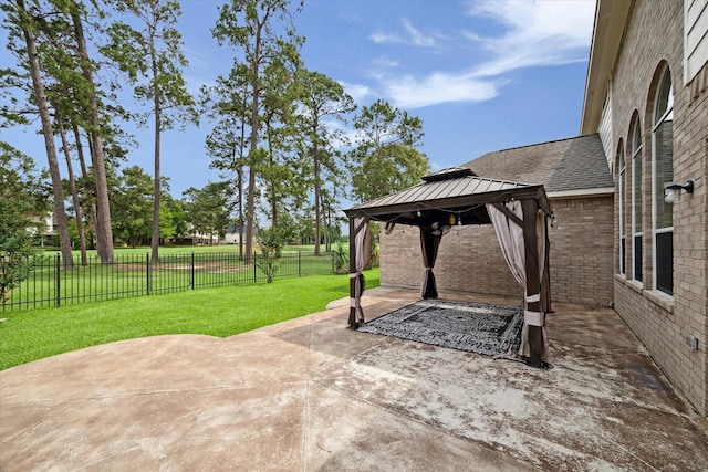 view of patio featuring a gazebo and a fenced backyard