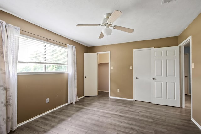 unfurnished bedroom with baseboards, ceiling fan, and wood finished floors