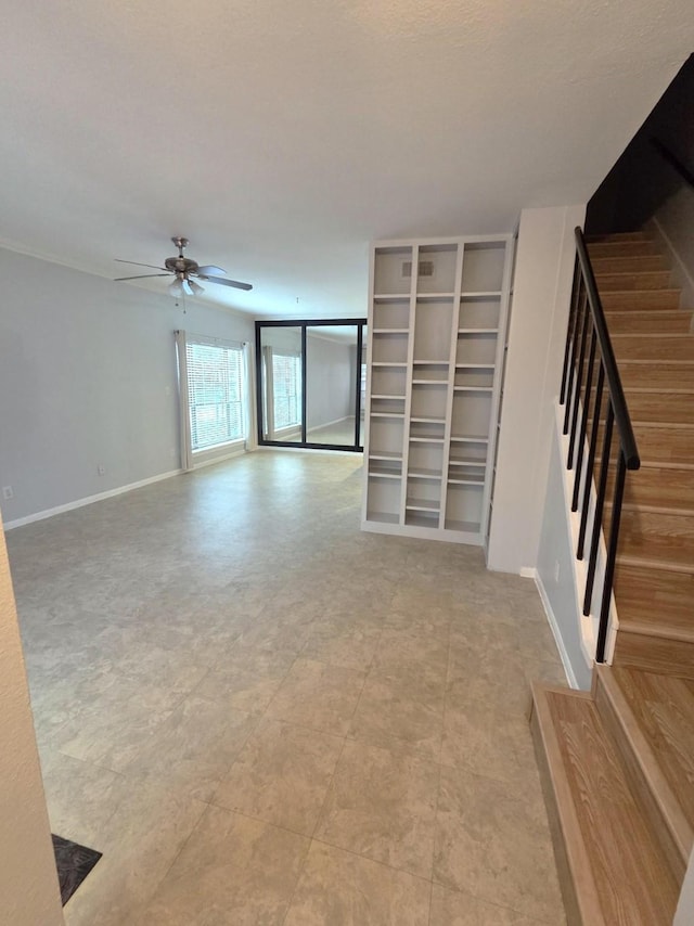 11711 Memorial Dr Unit 97, Houston, TX 77024 - unfurnished living room featuring baseboards, ceiling fan, and stairway