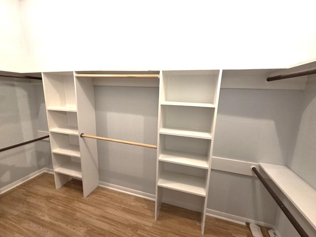 11711 Memorial Dr Unit 97, Houston, TX 77024 - walk in closet featuring wood finished floors