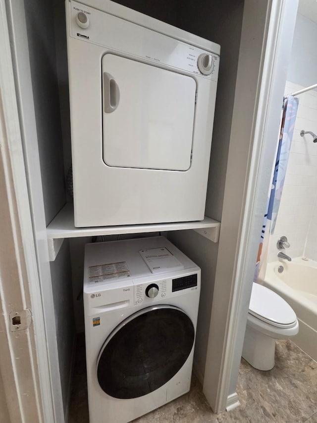 11711 Memorial Dr Unit 97, Houston, TX 77024 - clothes washing area featuring stacked washing maching and dryer and laundry area