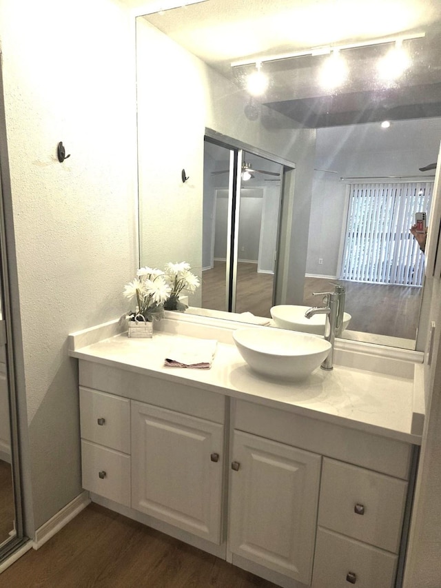 11711 Memorial Dr Unit 97, Houston, TX 77024 - bathroom featuring track lighting, wood finished floors, and vanity