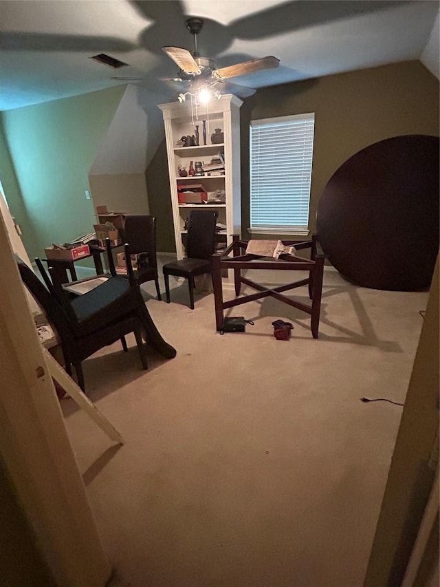 carpeted bedroom with a ceiling fan, lofted ceiling, and visible vents