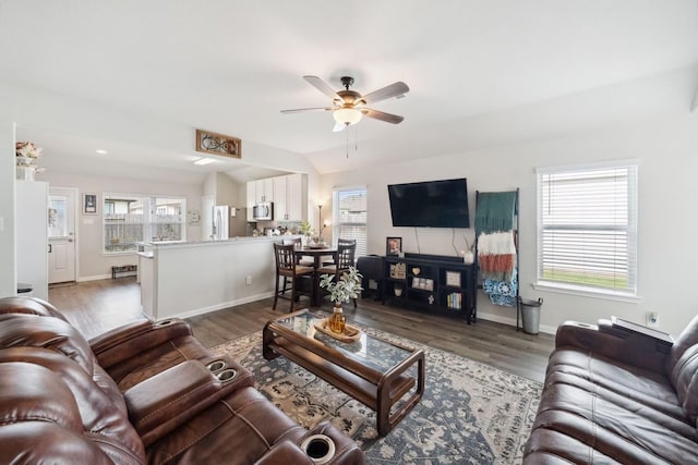 living area with ceiling fan, a healthy amount of sunlight, and wood finished floors