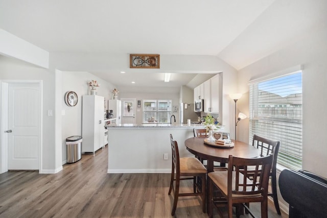 dining area featuring baseboards and wood finished floors