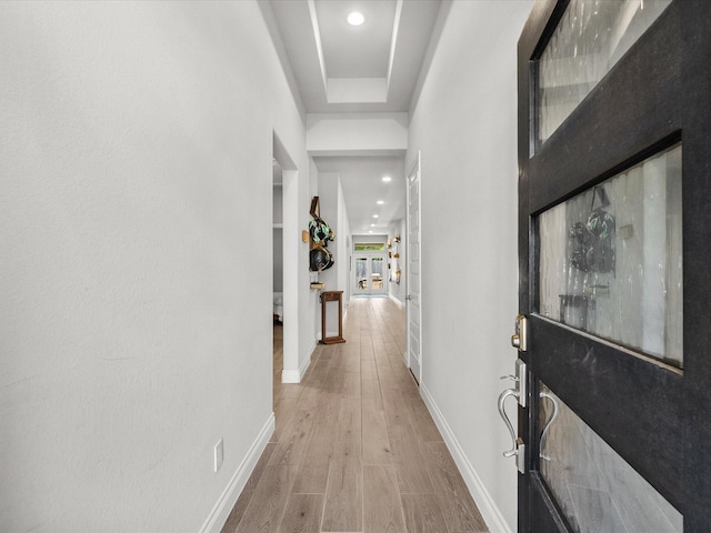 corridor featuring baseboards, recessed lighting, and wood finished floors